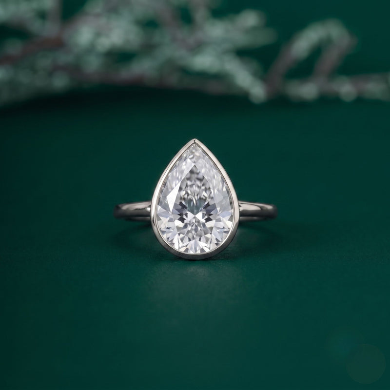 Pear solitaire engagement ring with solitaire pear ring.
