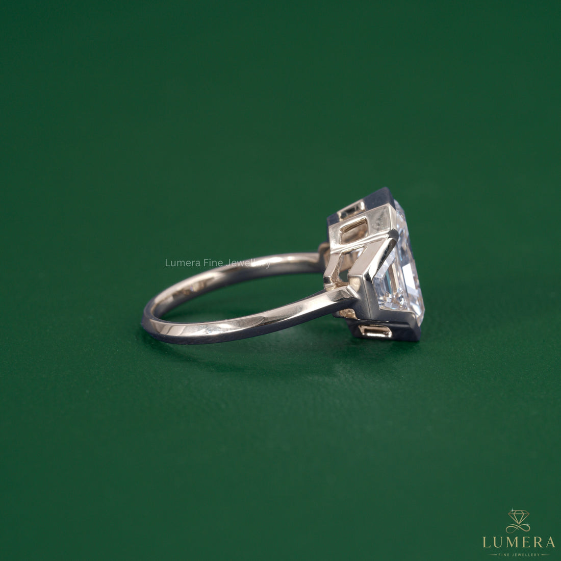 Trapezoid side stone set in a solid gold ring.