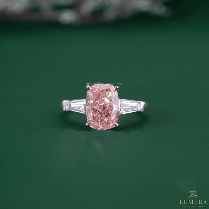 Cushion cut diamond engagement ring featuring a pink diamond ring.