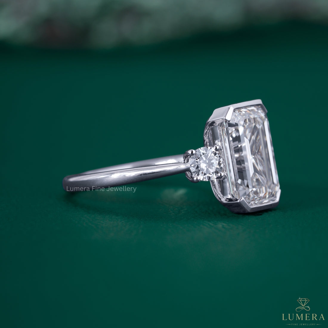 Emerald diamond ring with trilogy diamond ring.