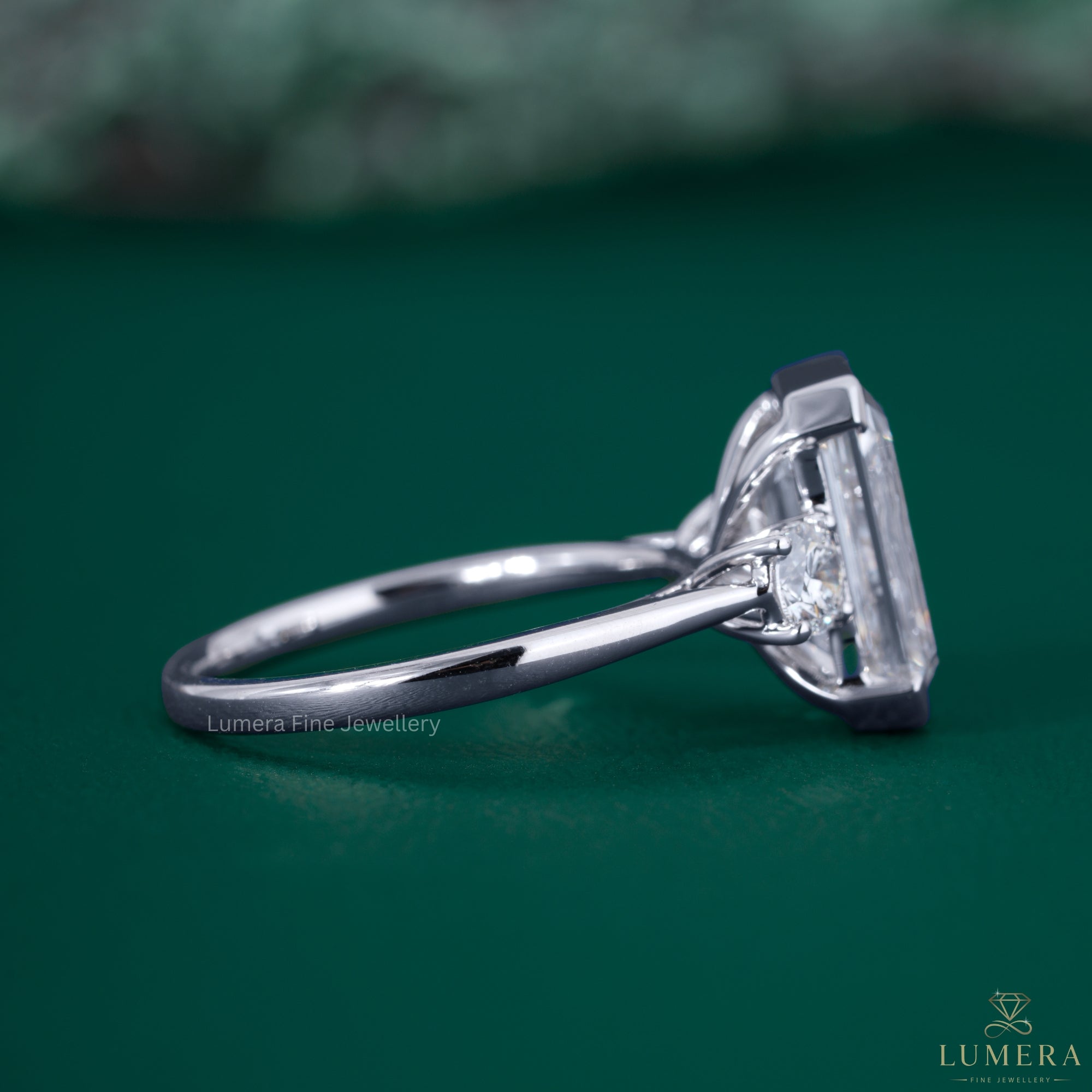 Round diamond side stone with three stone engagement ring.