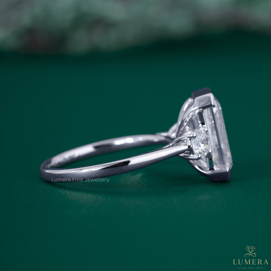 Round diamond side stone with three stone engagement ring.
