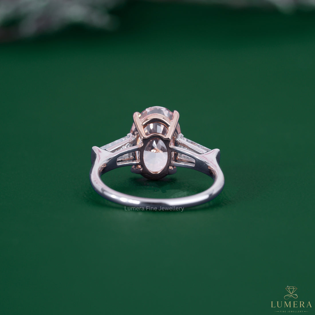 Pink diamond ring featuring an oval cut engagement ring.