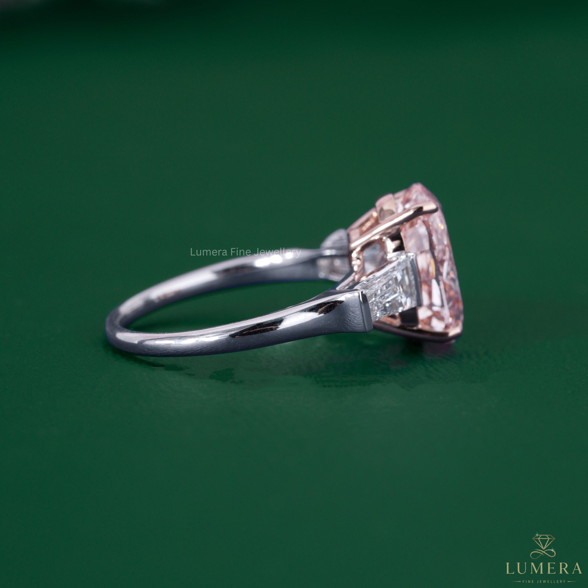 Oval diamond ring beside a three stone engagement ring.