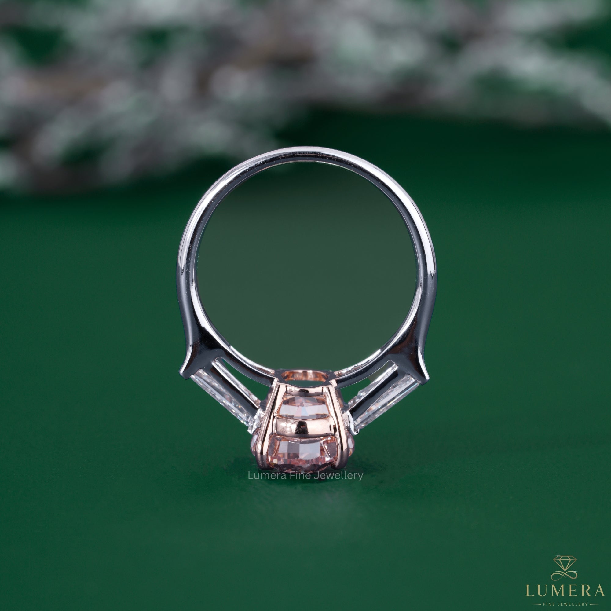 Three stone ring design featuring tapered side stones.