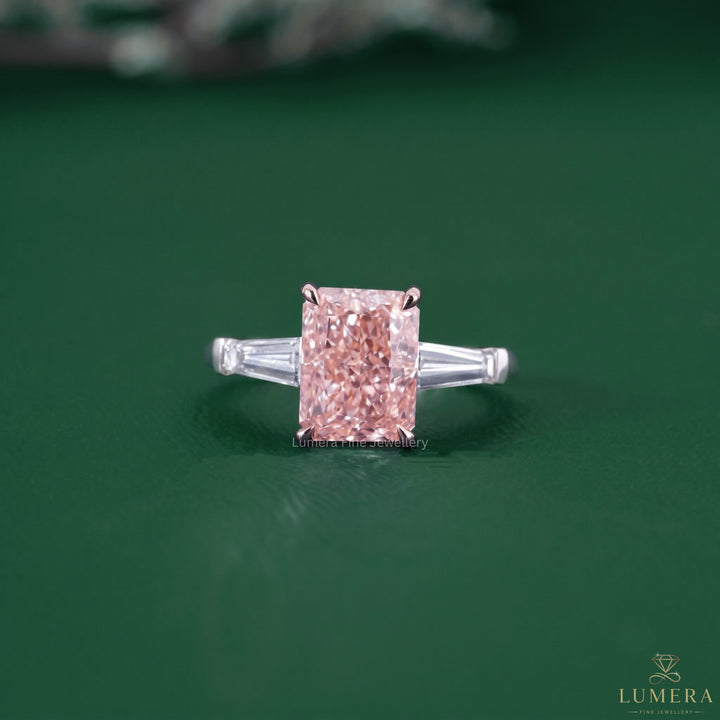 Radiant cut engagement ring featuring a pink diamond ring.
