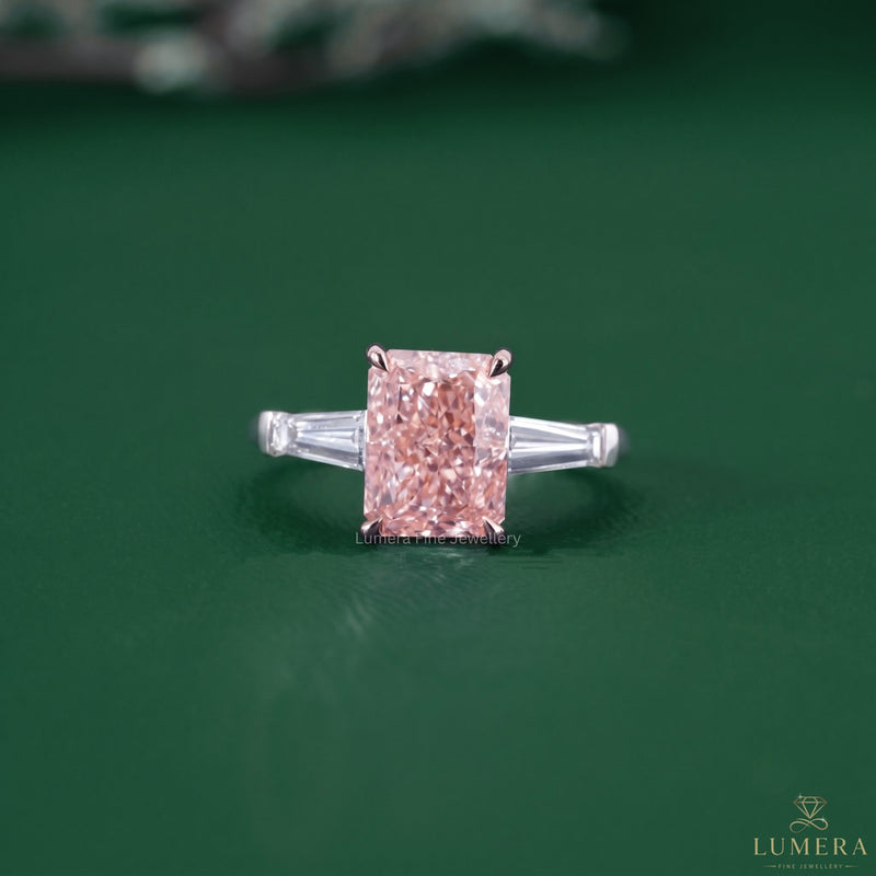 Radiant cut engagement ring featuring a pink diamond ring.