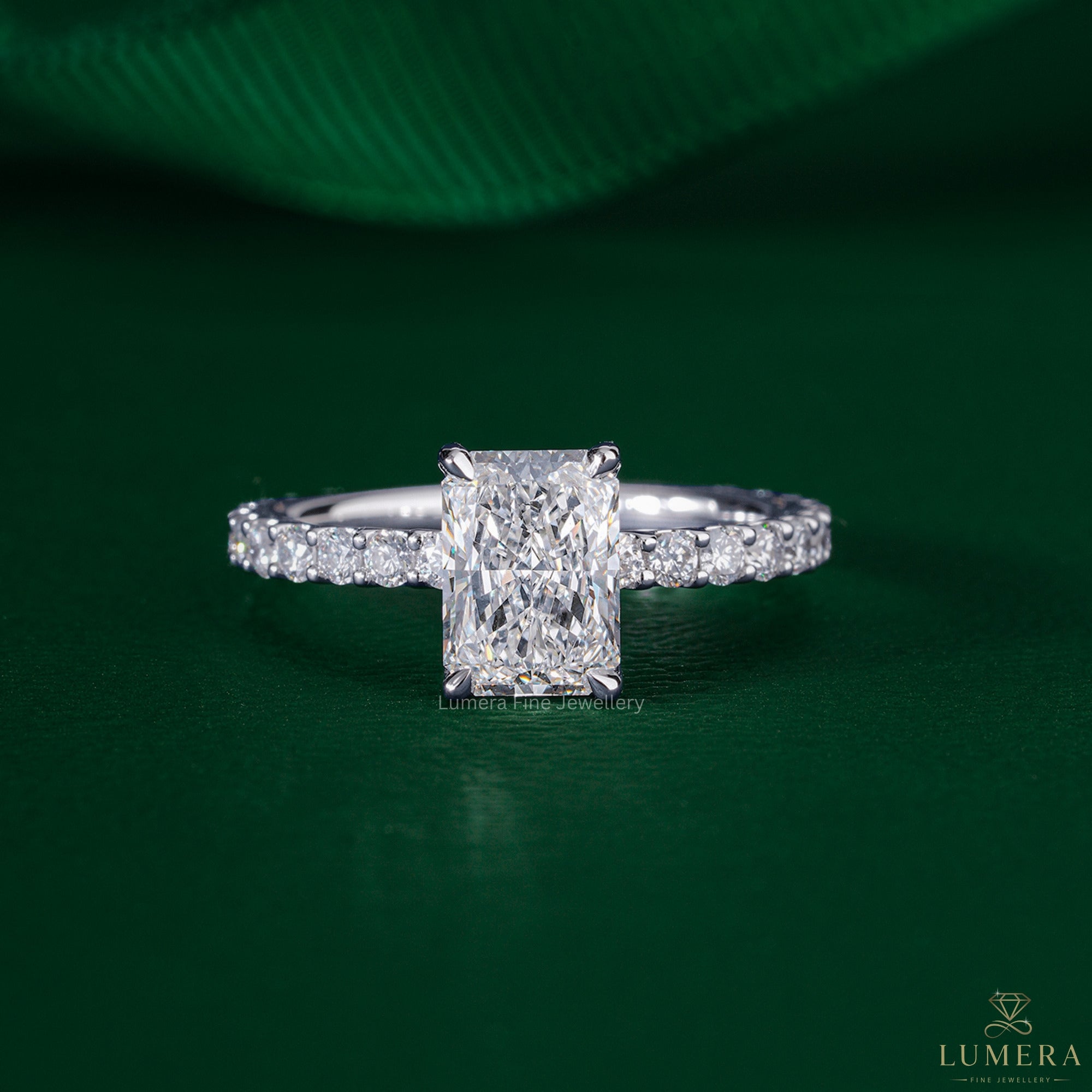 Radiant cut diamond engagement ring featuring a U prong pave band.