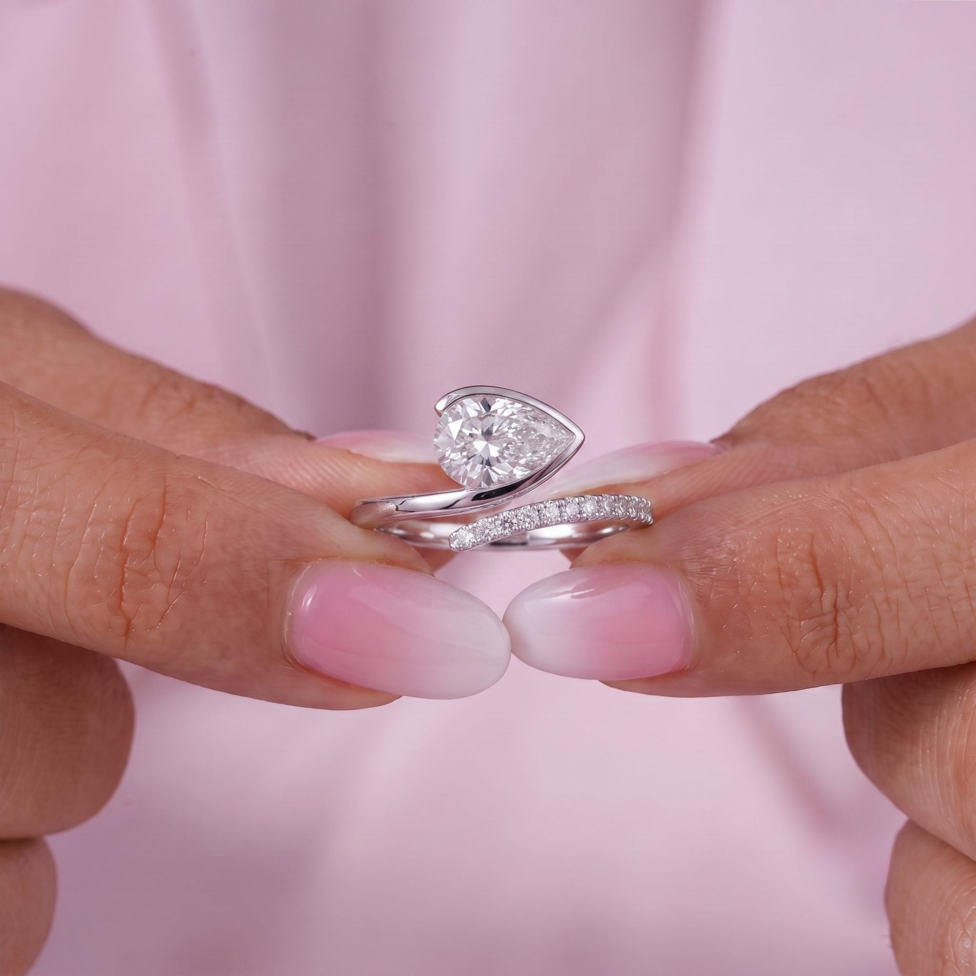 Solitaire accent ring with Pear bezel ring.
