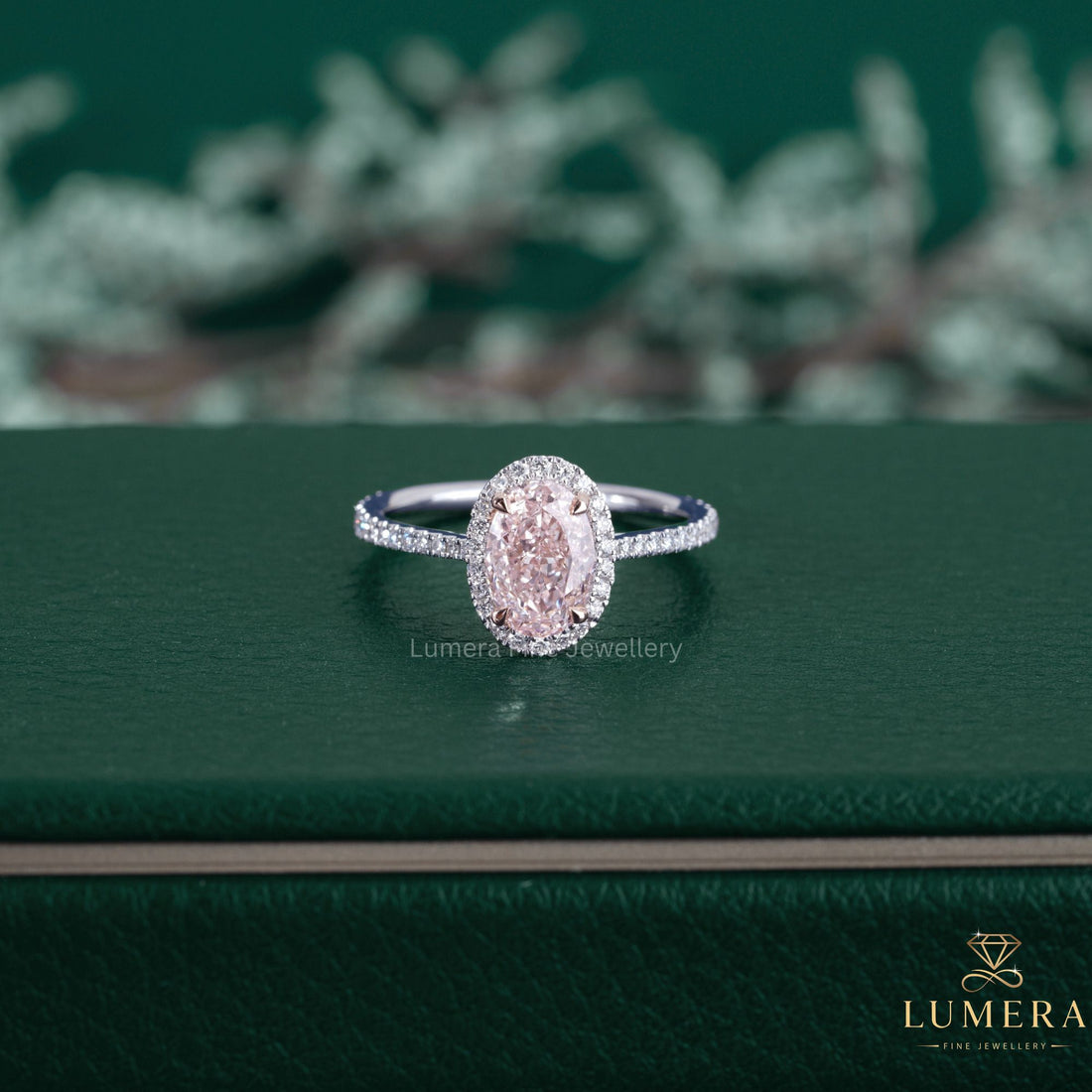 Fancy pink color diamond ring featuring an oval cut engagement ring.