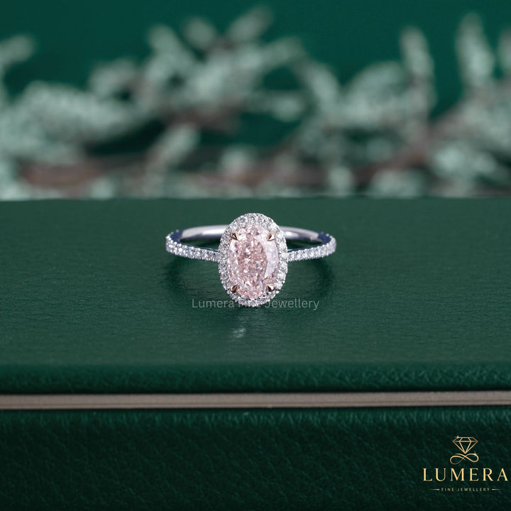 Fancy pink color diamond ring featuring an oval cut engagement ring.