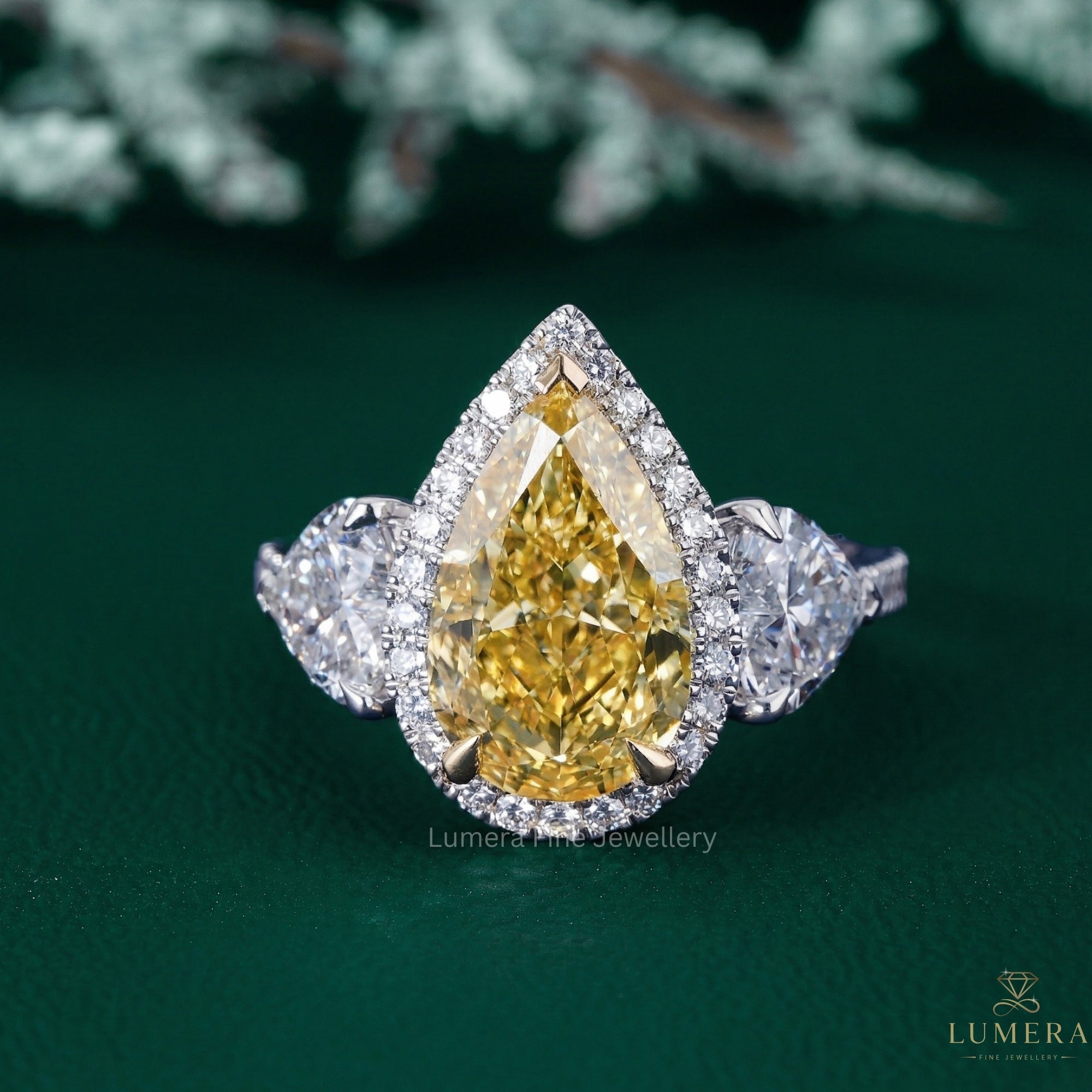 pear shaped diamond ring with heart shape side stone.