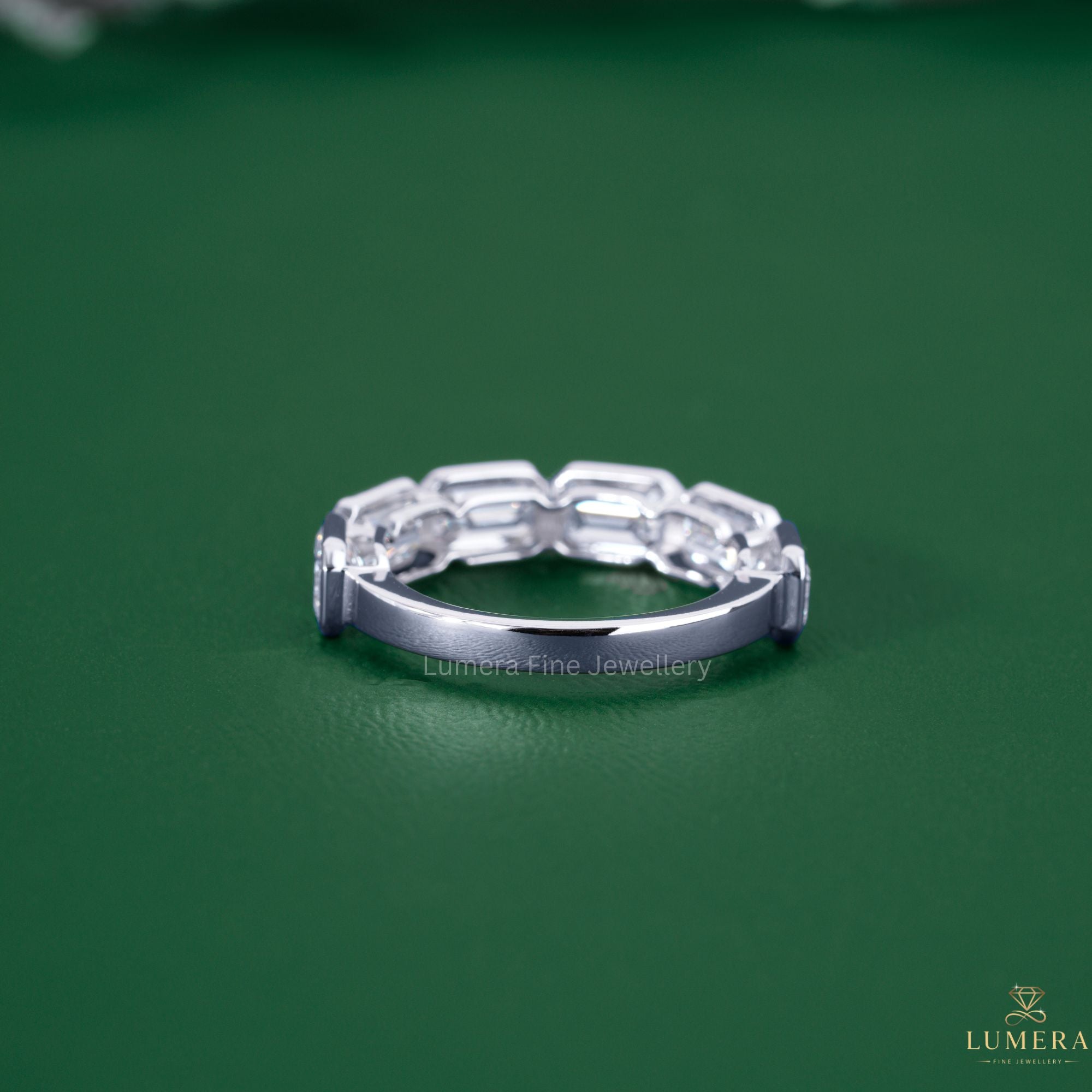 Emerald half eternity band with six stone band.