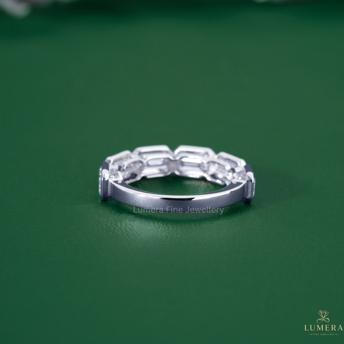 Emerald half eternity band with six stone band.
