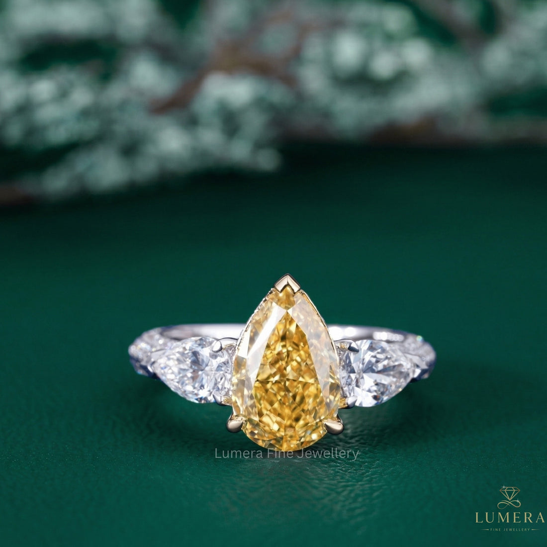pear shaped yellow diamond ring with three stone diamond ring.