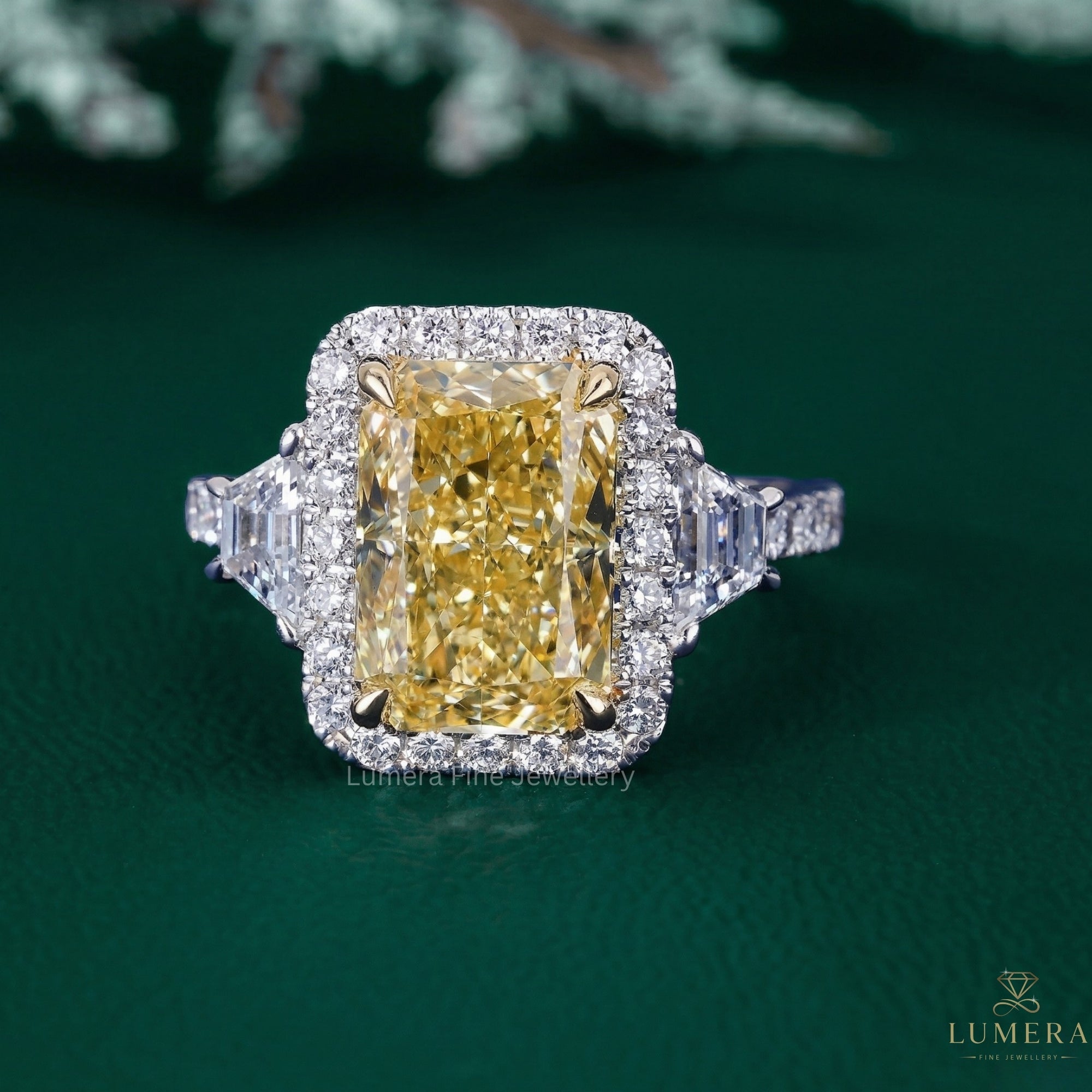 Radiant diamond engagement ring with trapezoid side stone.