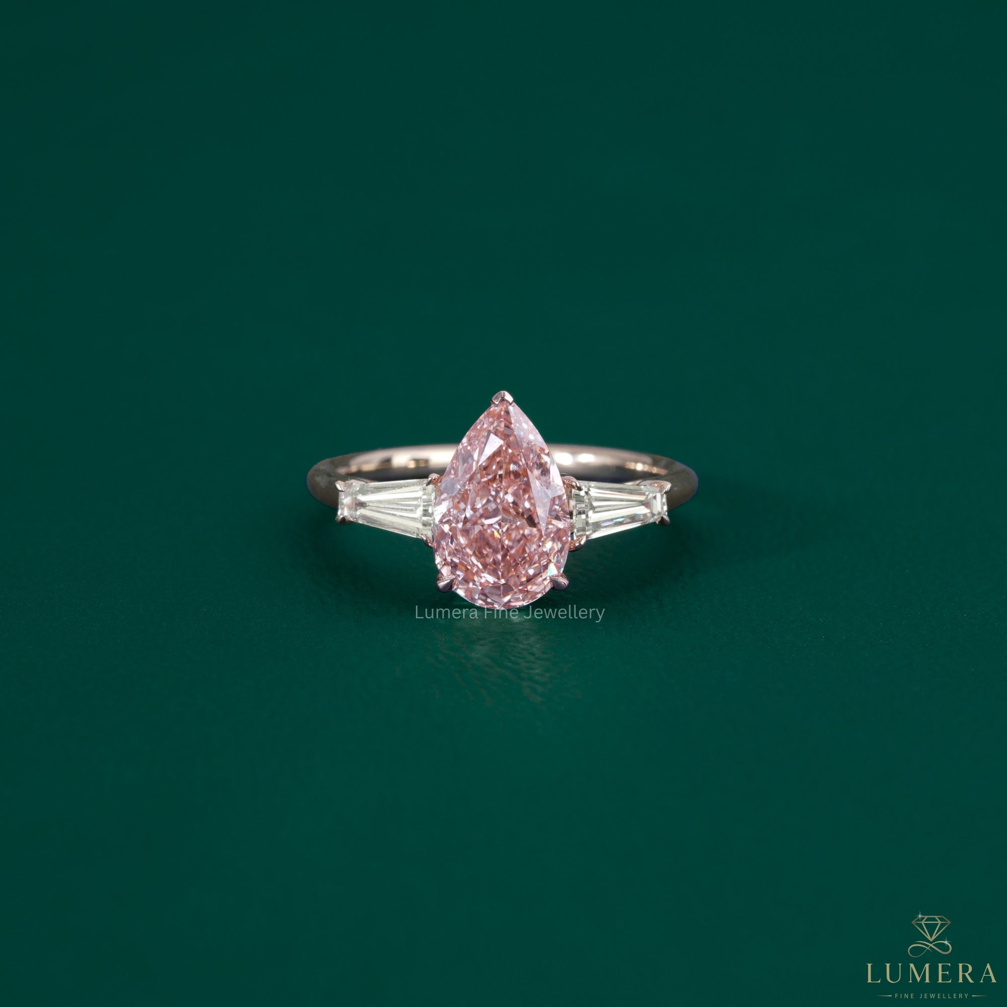 Pink diamond ring featuring a V prong setting.
