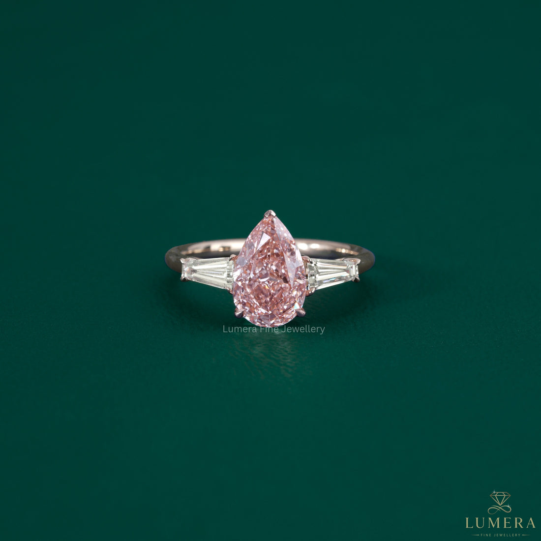 Pink diamond ring featuring a V prong setting.