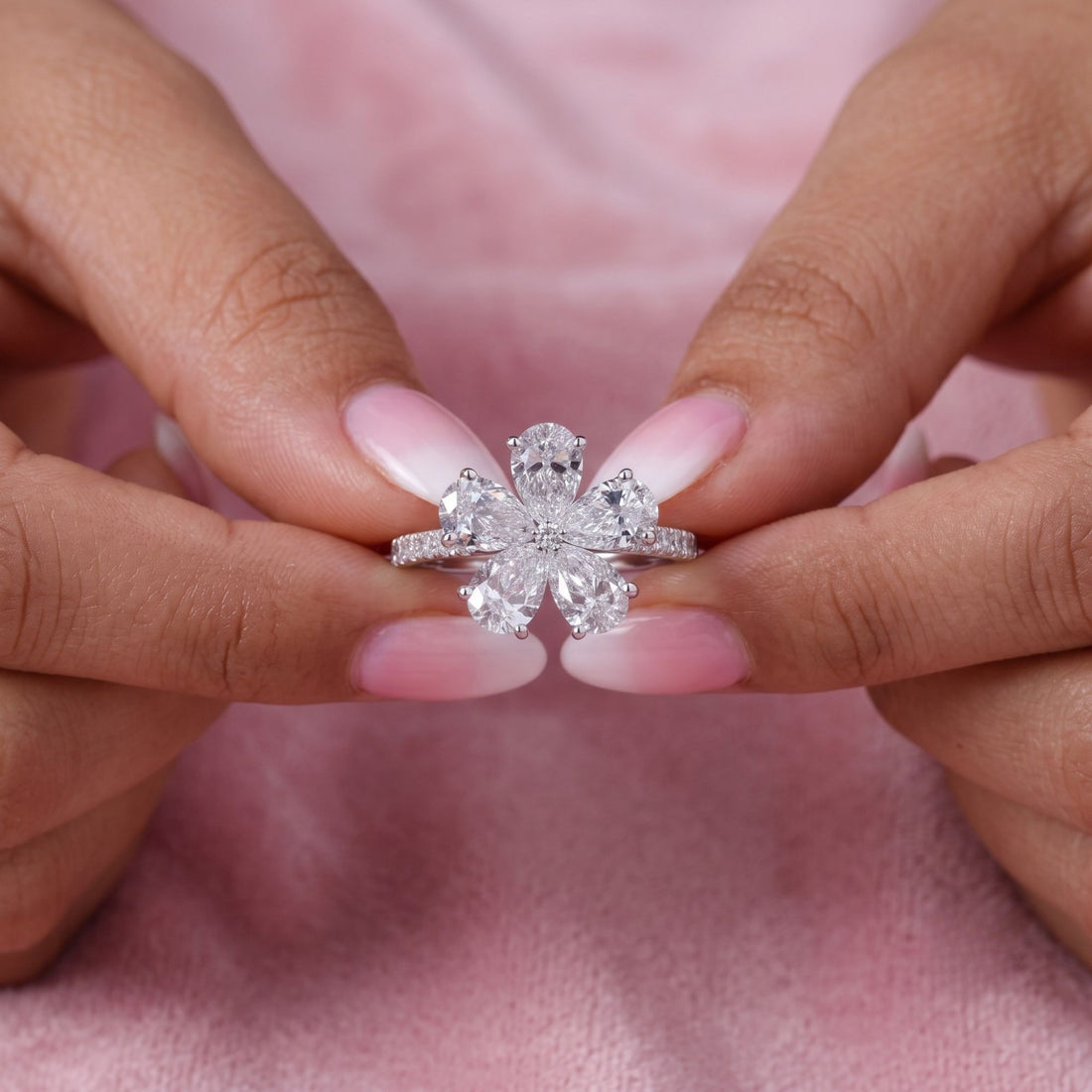 pear diamond engagement ring with round diamond side stone.
