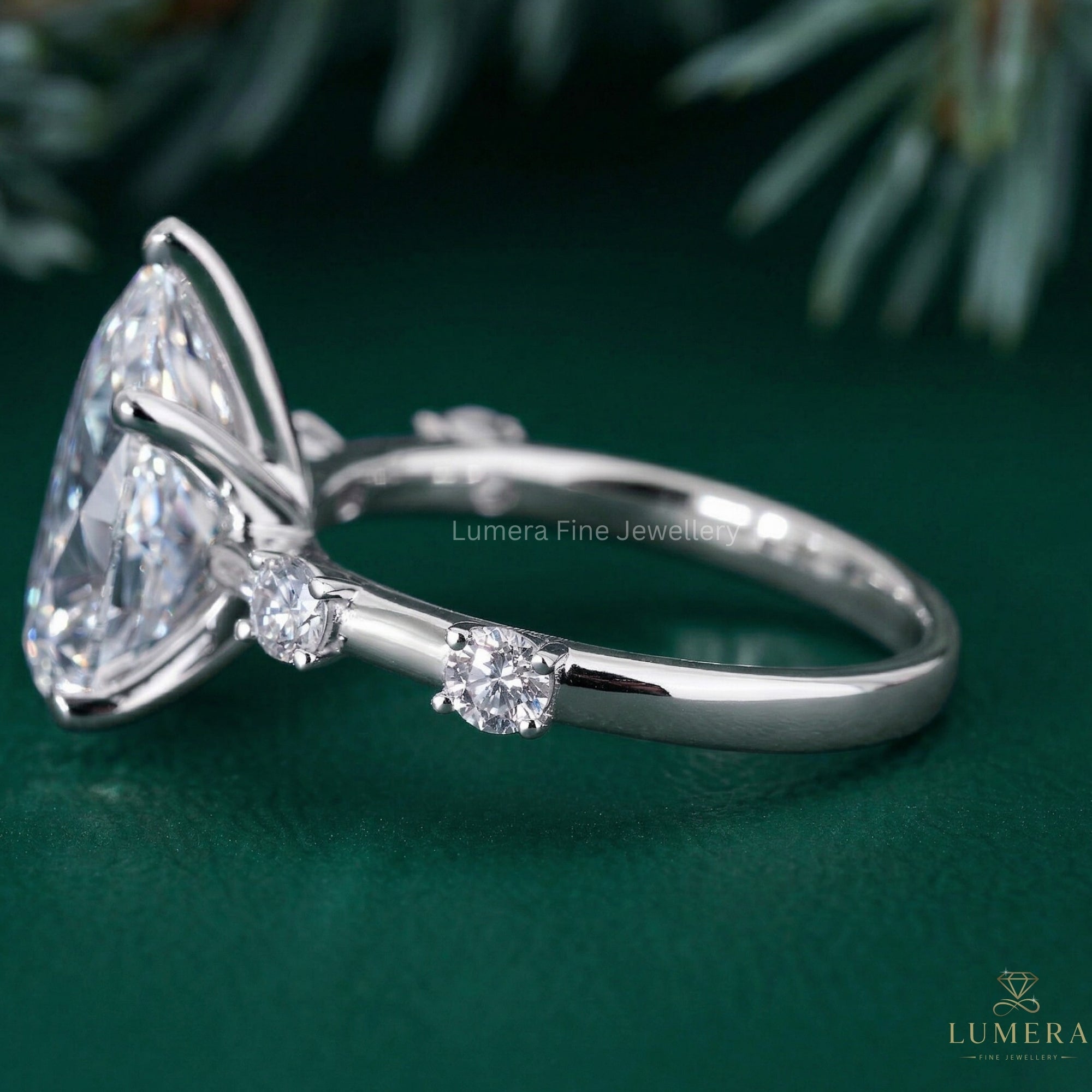 almond diamond ring with round cut side stones.
