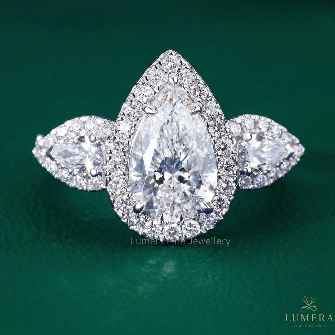 pear shaped three stone diamond ring with trellis setting ring.