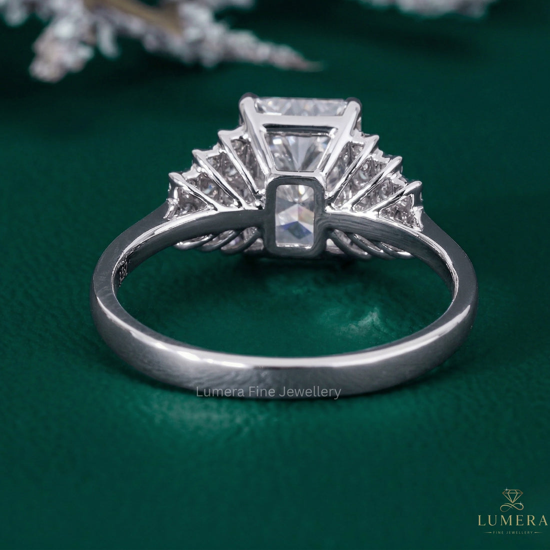 radiant cut diamond ring with round cut side stones.
