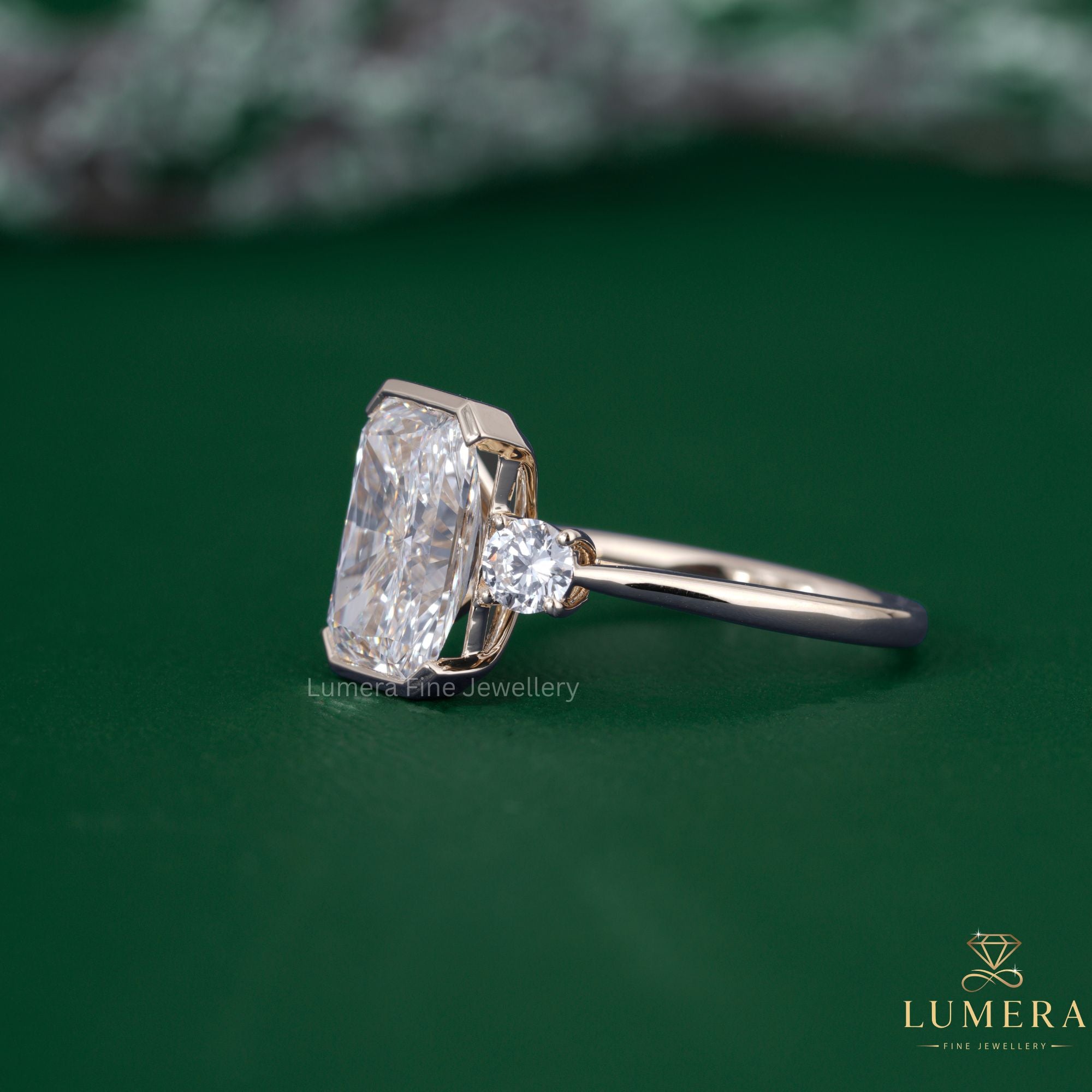 Three stone diamond ring with round cut side stones.