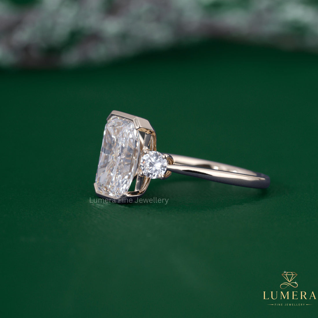 Three stone diamond ring with round cut side stones.