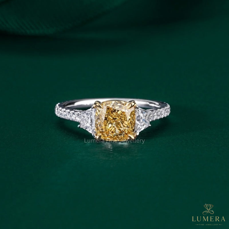 cushion cut yellow diamond ring with two tone gold ring.