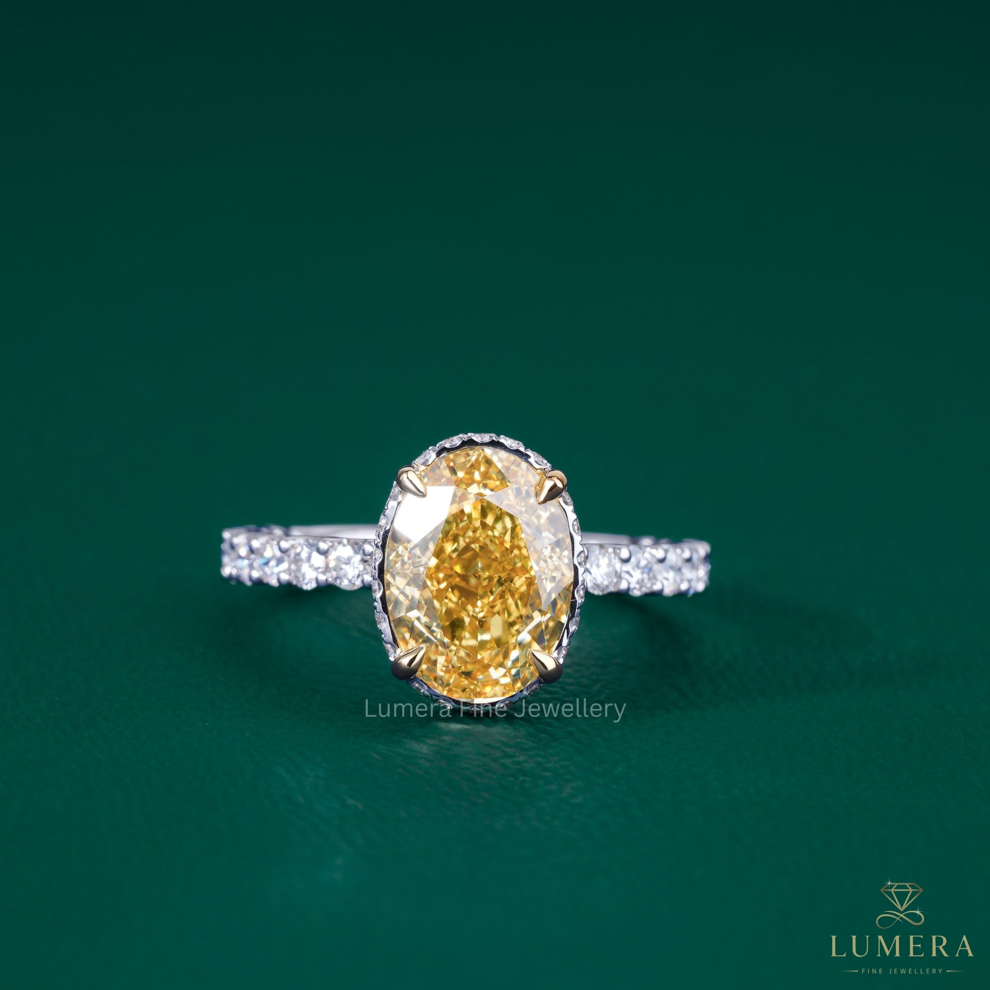 oval yellow diamond engagement ring​ with two tone ring​.