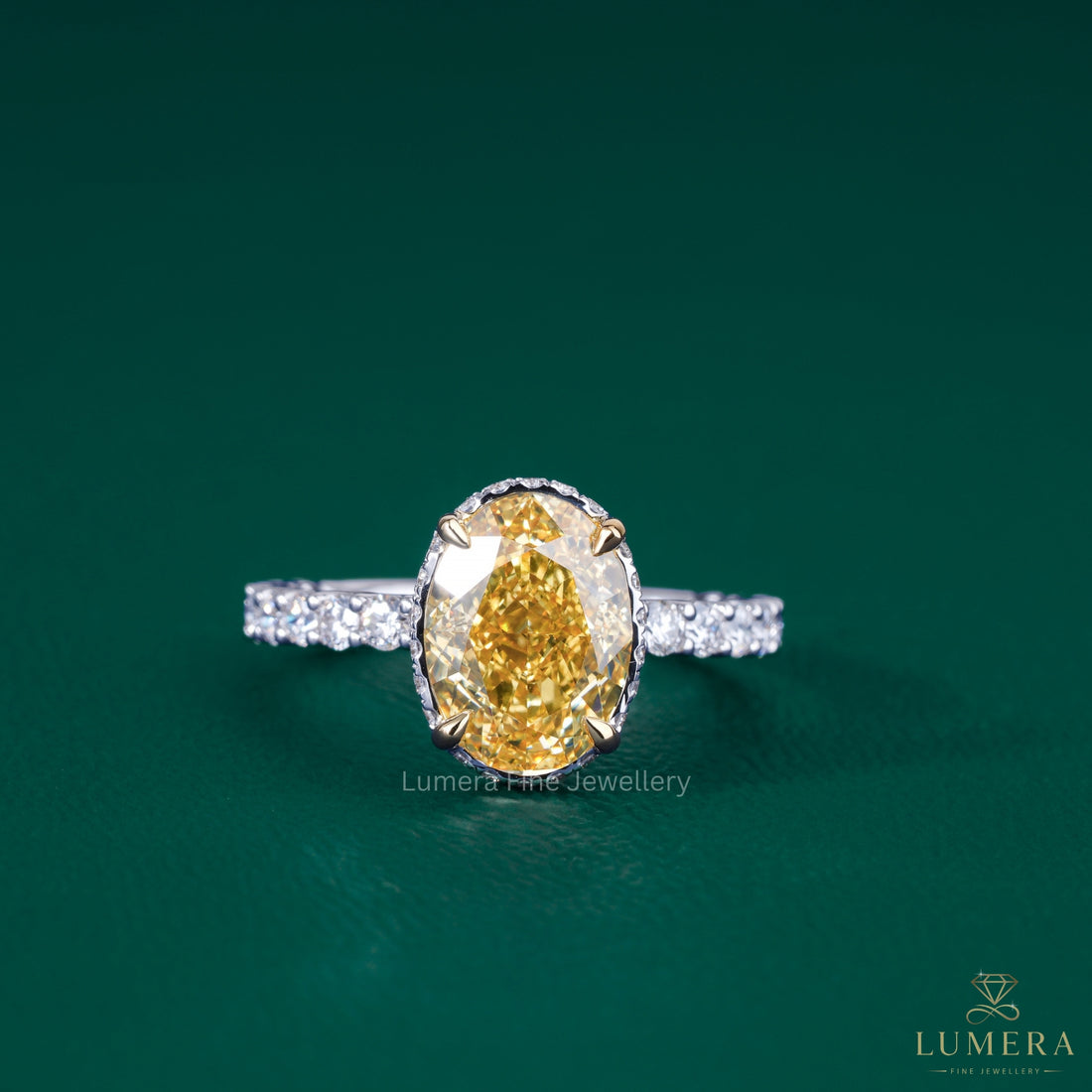 oval yellow diamond engagement ring​ with two tone ring​.