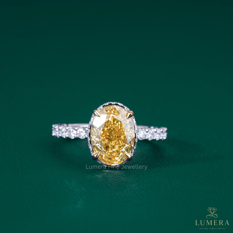 oval yellow diamond engagement ring​ with two tone ring​.