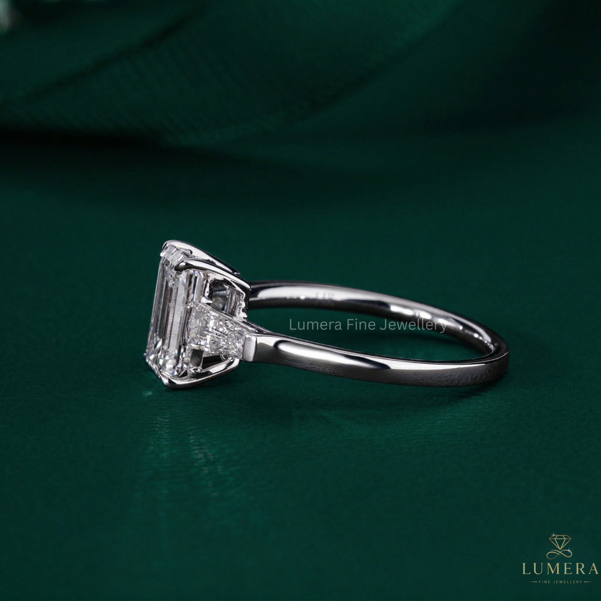 emerald engagement ring with trilogy diamond ring.
