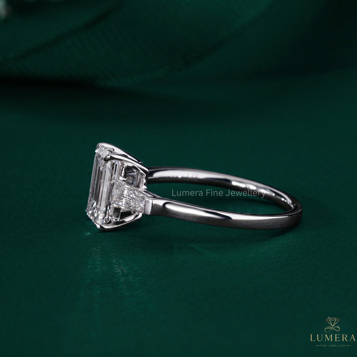emerald engagement ring with trilogy diamond ring.
