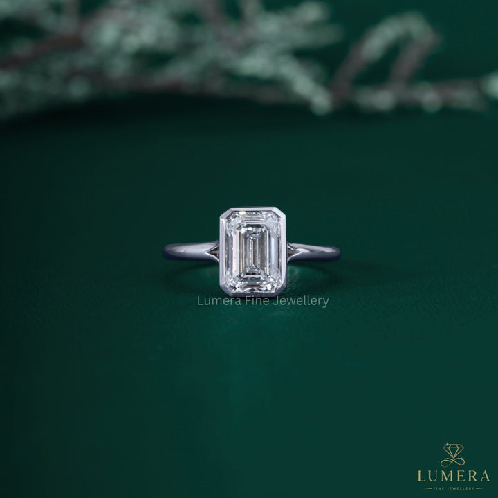 Emerald diamond solitaire ring with emerald cut ring.