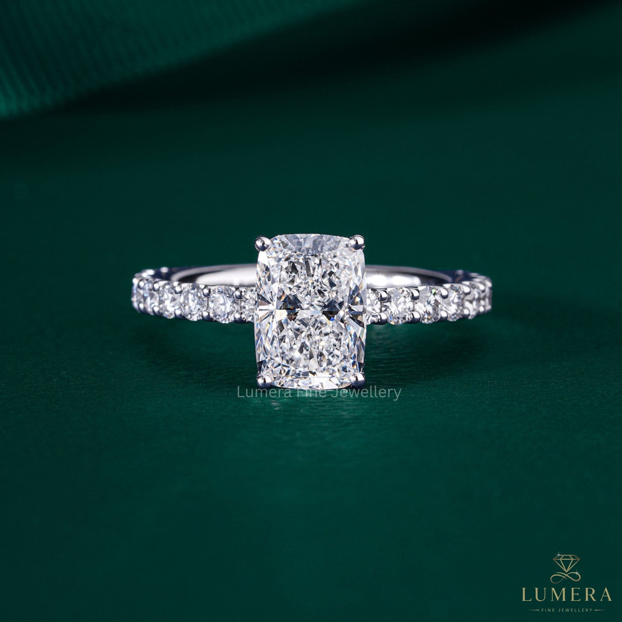 elongated cushion cut engagement ring with shared U prong setting.