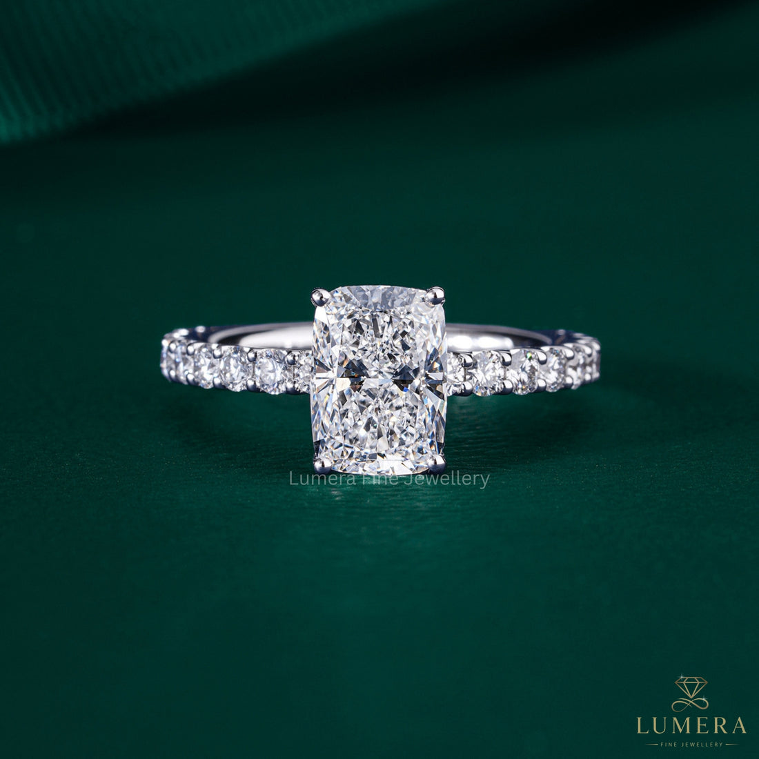 elongated cushion cut engagement ring with shared U prong setting.