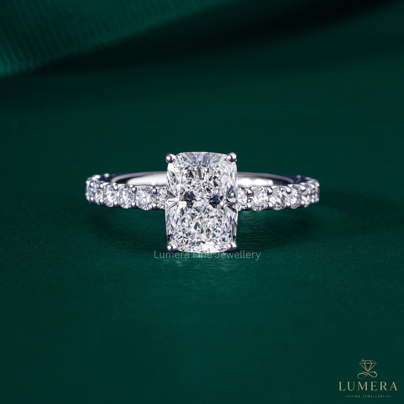 elongated cushion cut engagement ring with shared U prong setting.