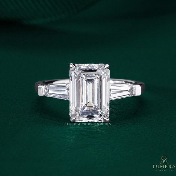 three stone diamond ring with emerald cut engagement ring.
