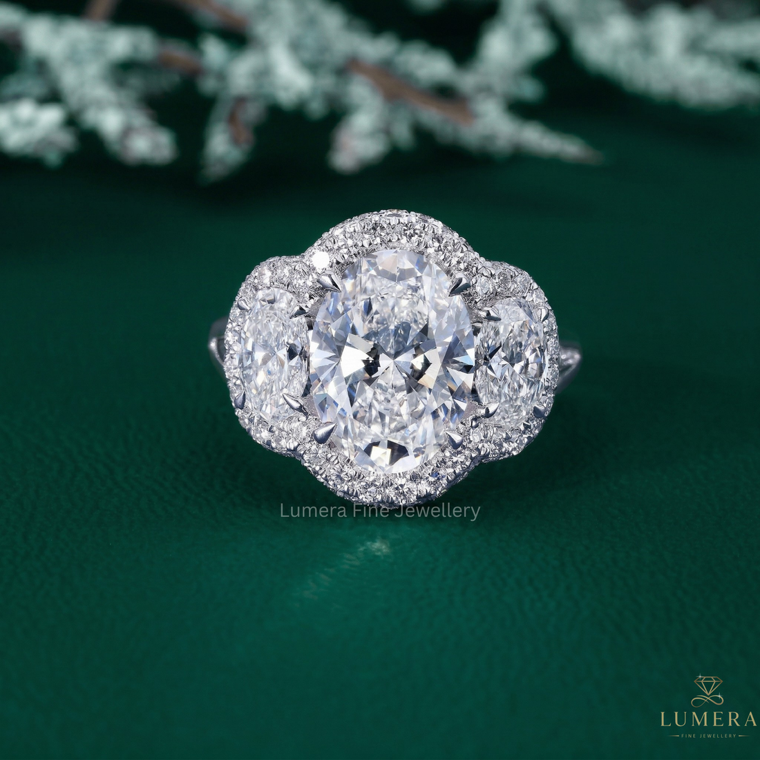 three stone engagement ring with oval cut side stones.