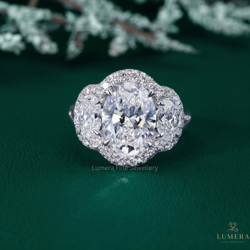 three stone engagement ring with oval cut side stones.