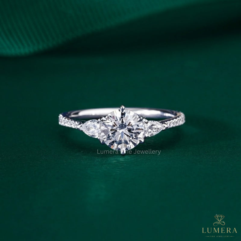 three stone round engagement ring with tapered shank ring.