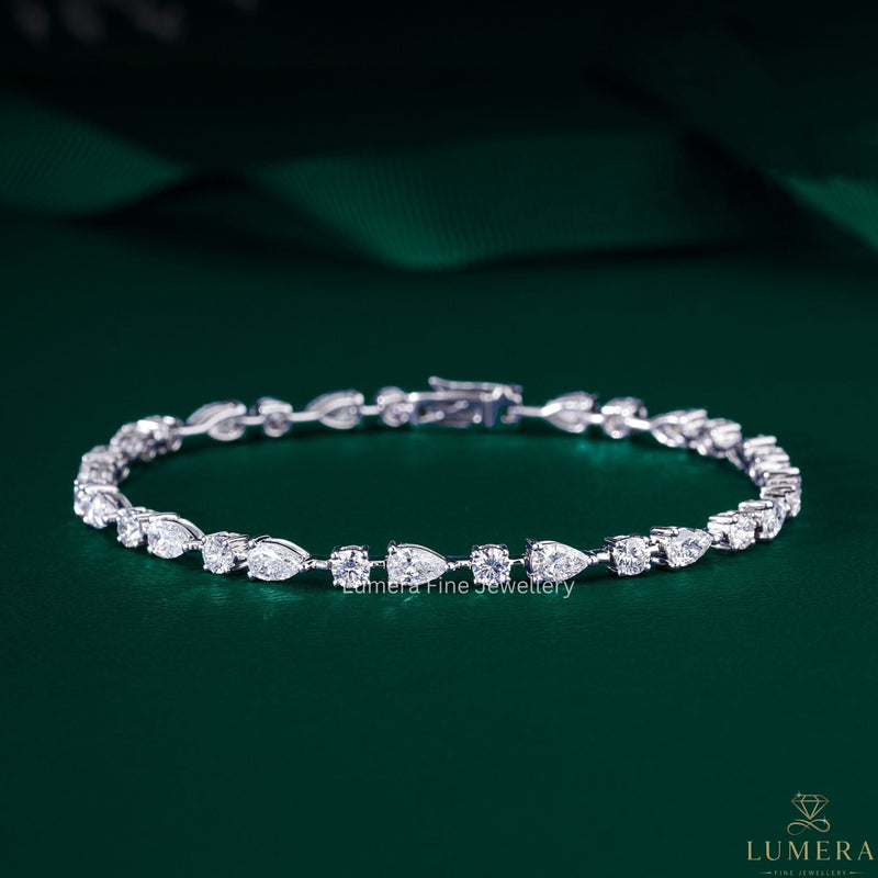 pear and round diamond bracelet with round diamond tennis bracelet.