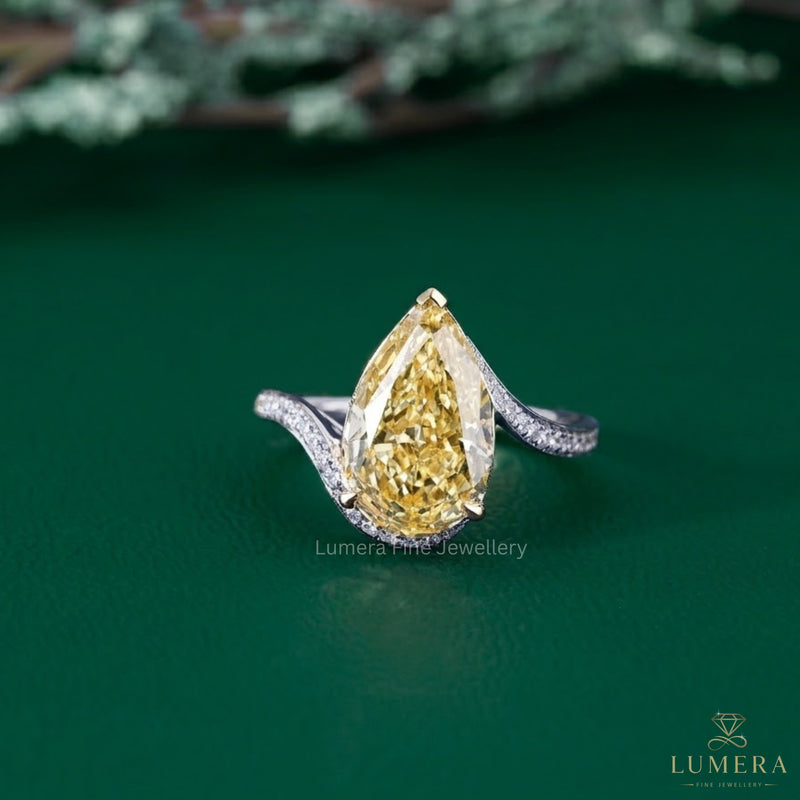pear shaped yellow diamond ring with bypass pave engagement ring.
