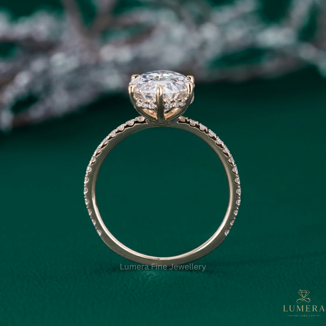 hidden halo diamond ring with oval step cut engagement ring.