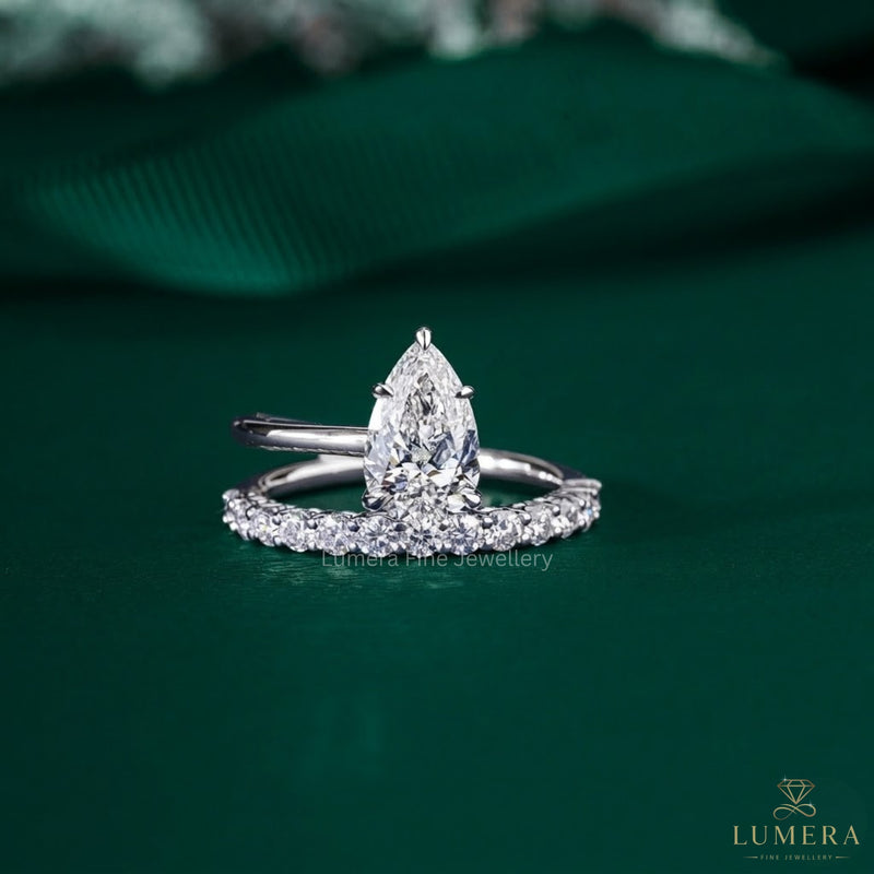 pear shaped diamond ring with 2 row band.