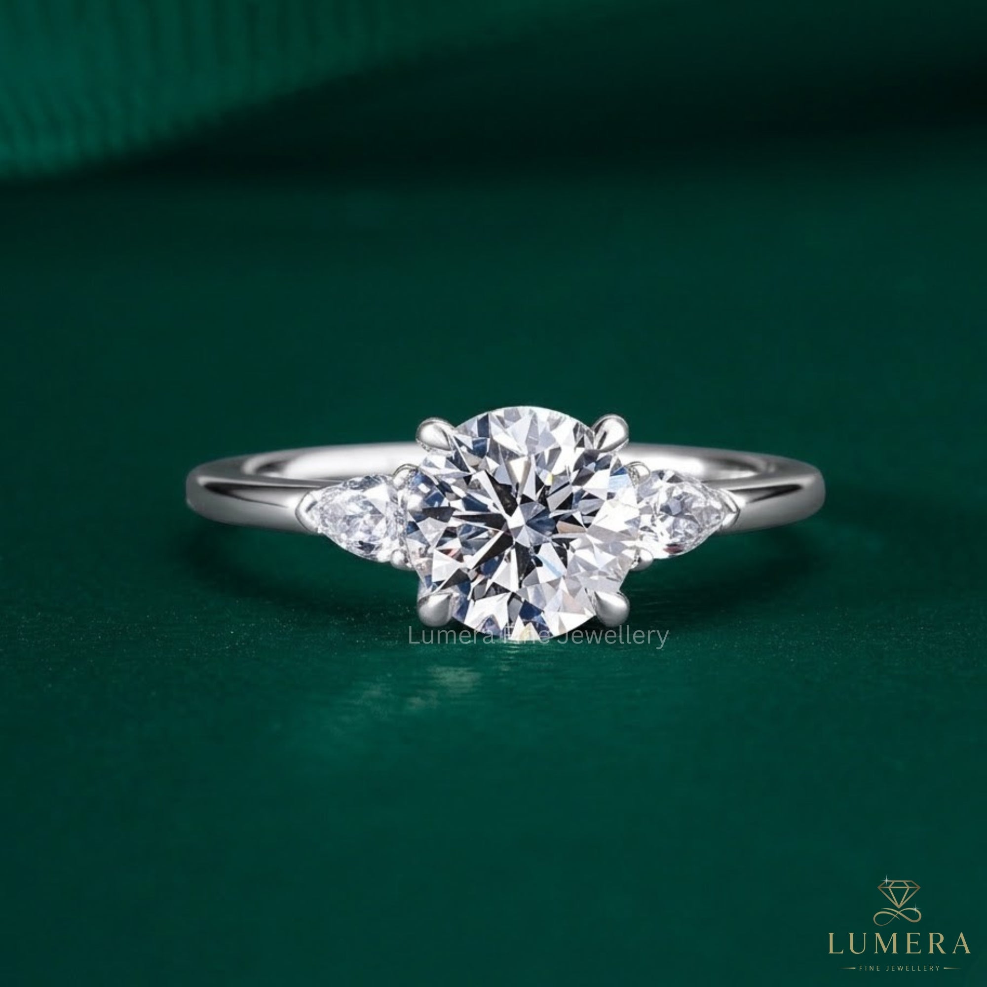 three stone diamond ring with trillion ring.
