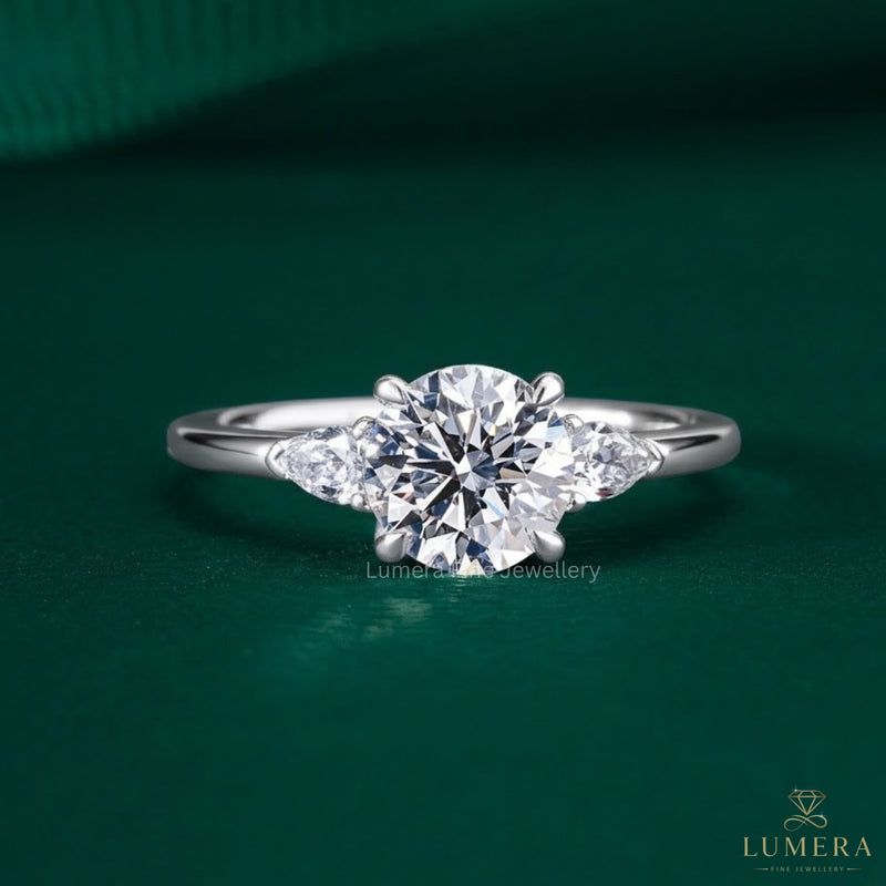 three stone diamond ring with trillion ring.
