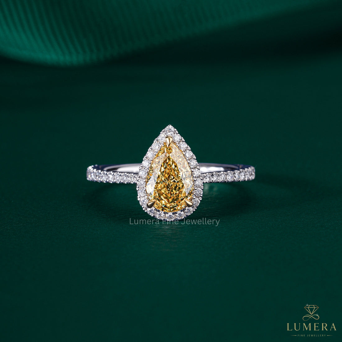 pear shaped yellow diamond ring with two tone engagement ring.