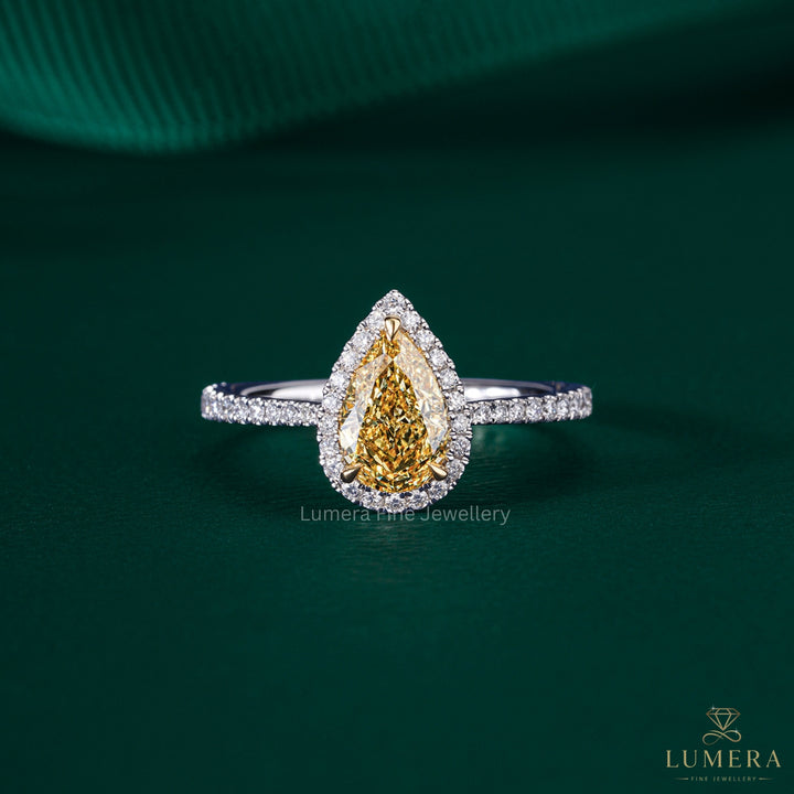 pear shaped yellow diamond ring with two tone engagement ring.